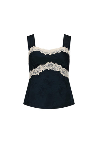  posing in front of a fireplace in a warm-toned interior.