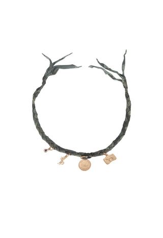 A dark green braided leather necklace with branch-like ends and three gold-toned charms, including a small horse figure and a round medallion, shown on a plain white background.