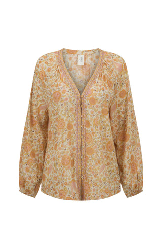 A long-sleeve V-neck blouse with a dense floral and paisley print in shades of orange, beige, and yellow, shown against a plain white background.